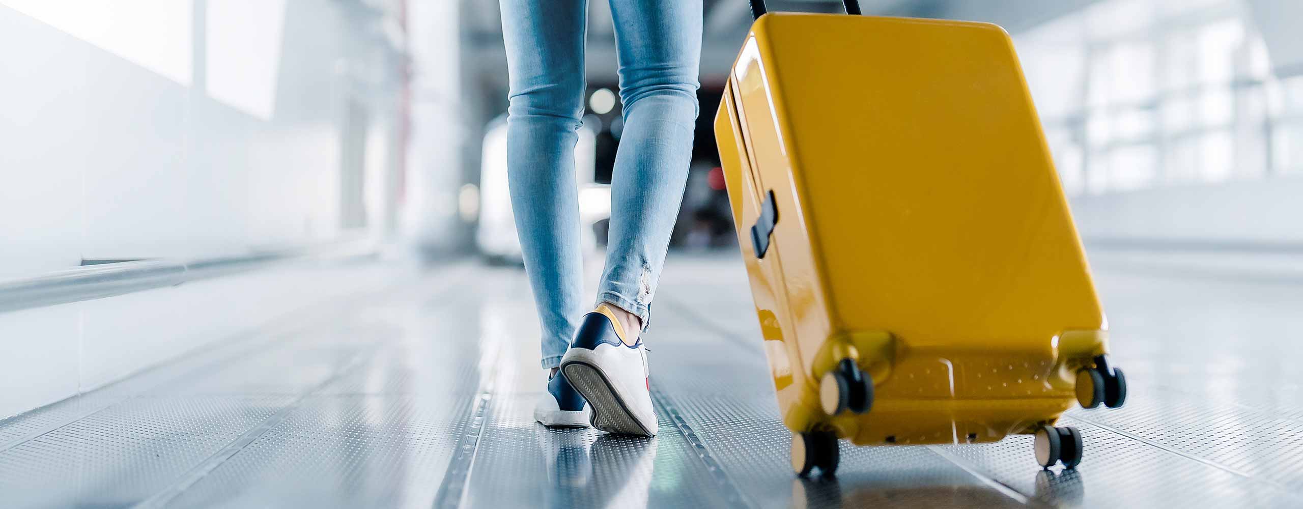 Woman pulling suitcase through airport