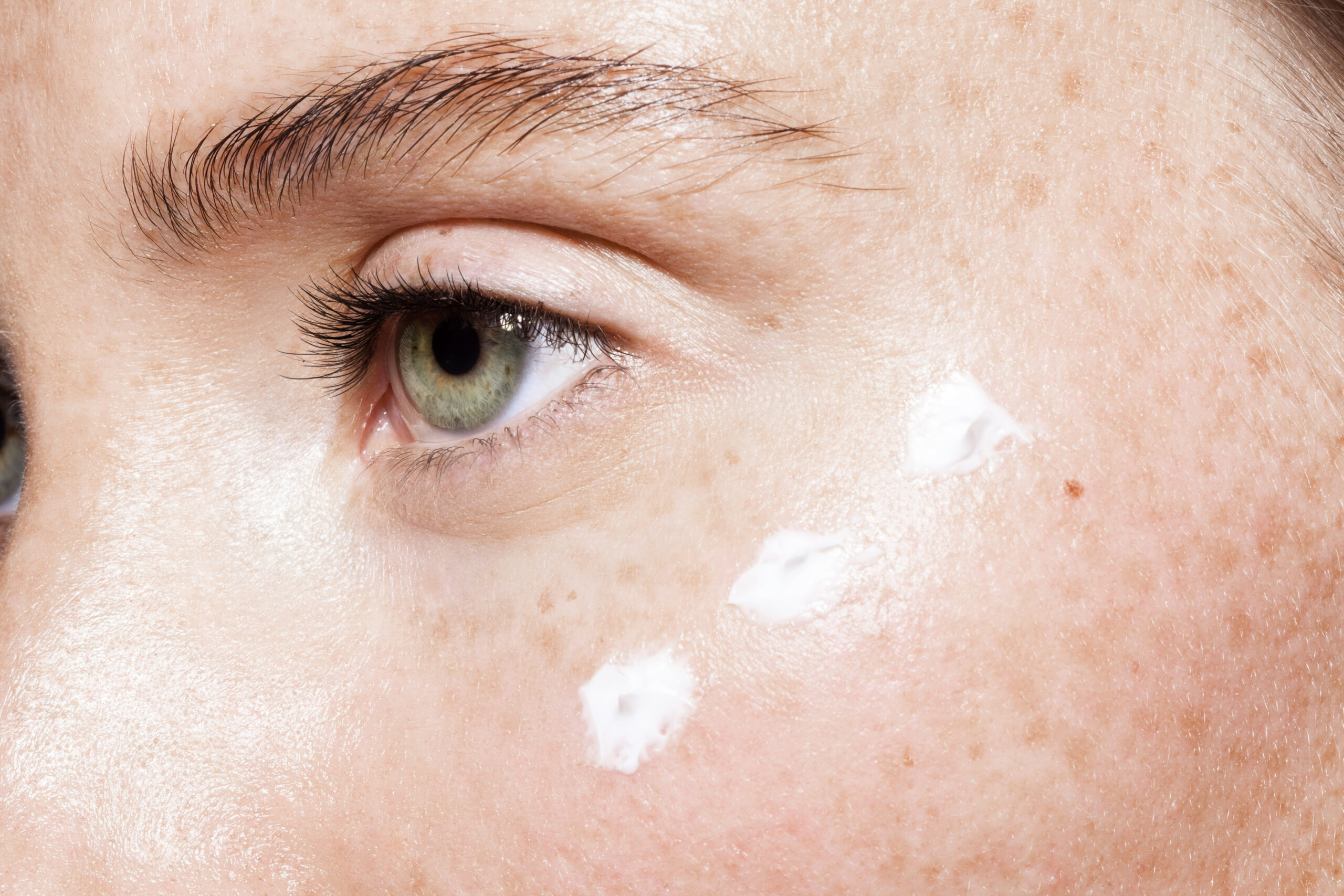 woman with eye cream
